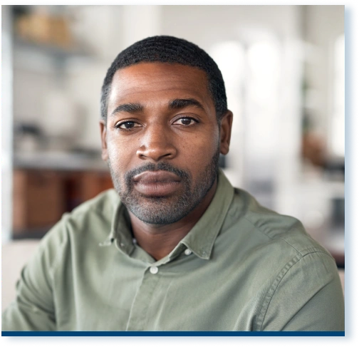 A 45-year-old black man looking seriously at the camera