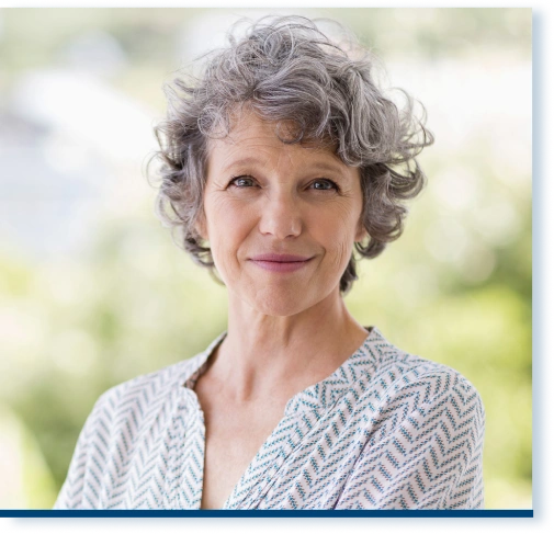 A 55-year-old white woman smiling at the camera